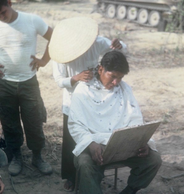 One of our cooks, "Chief" getting a haircut.