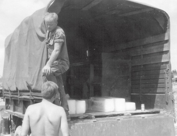 K Troop mess truck driver, Larry Blumenstock delivers ice.