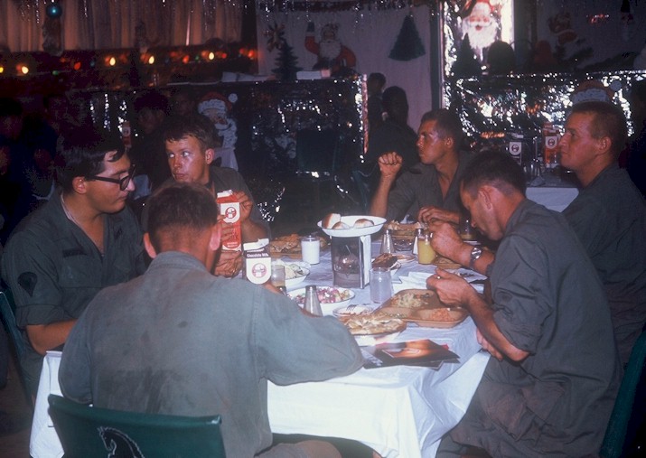 Crewmembers take a brake from performing maintenance on their vehicles to enjoy Christmas dinner.